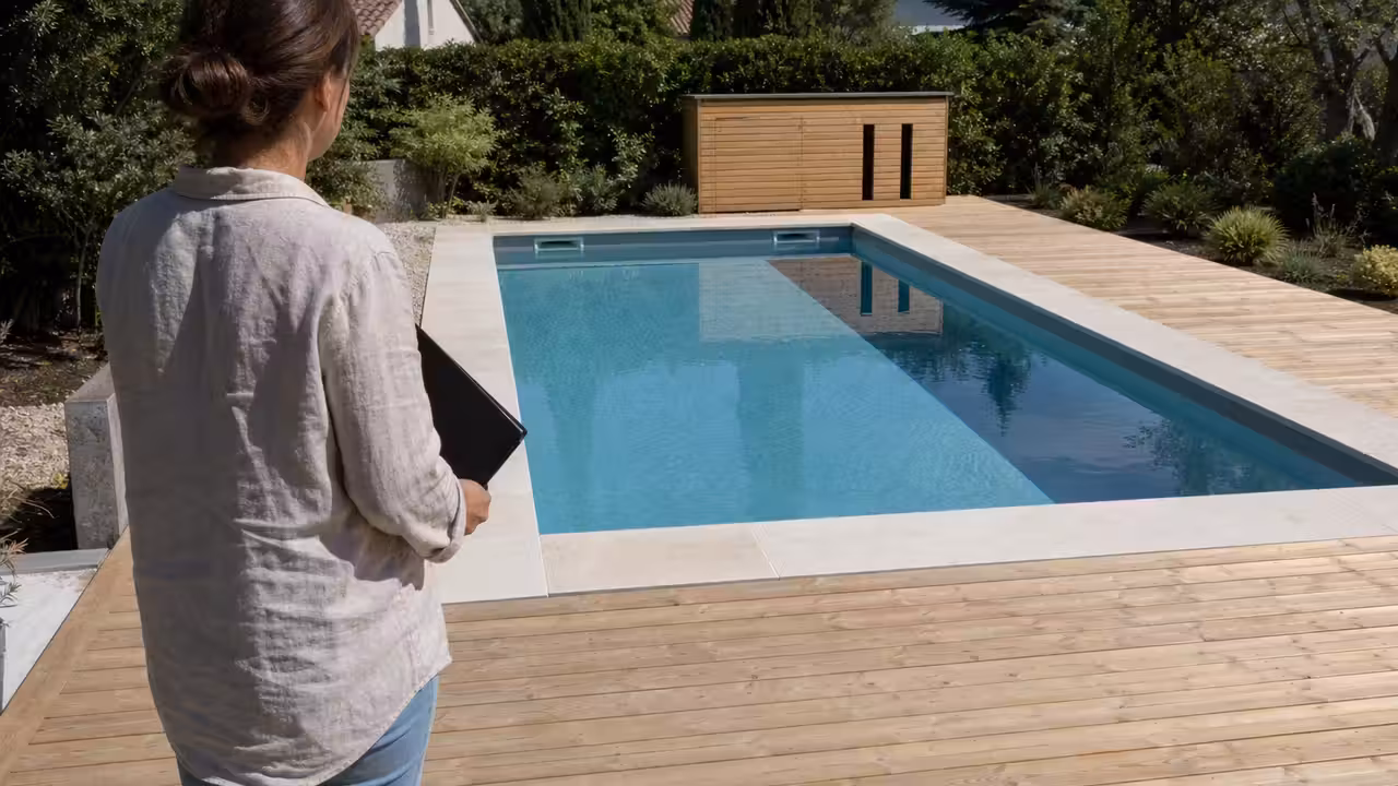 Piscine enterrée rectangulaire neuve dans un jardin, avec terrasse et espace technique en cours de finition
