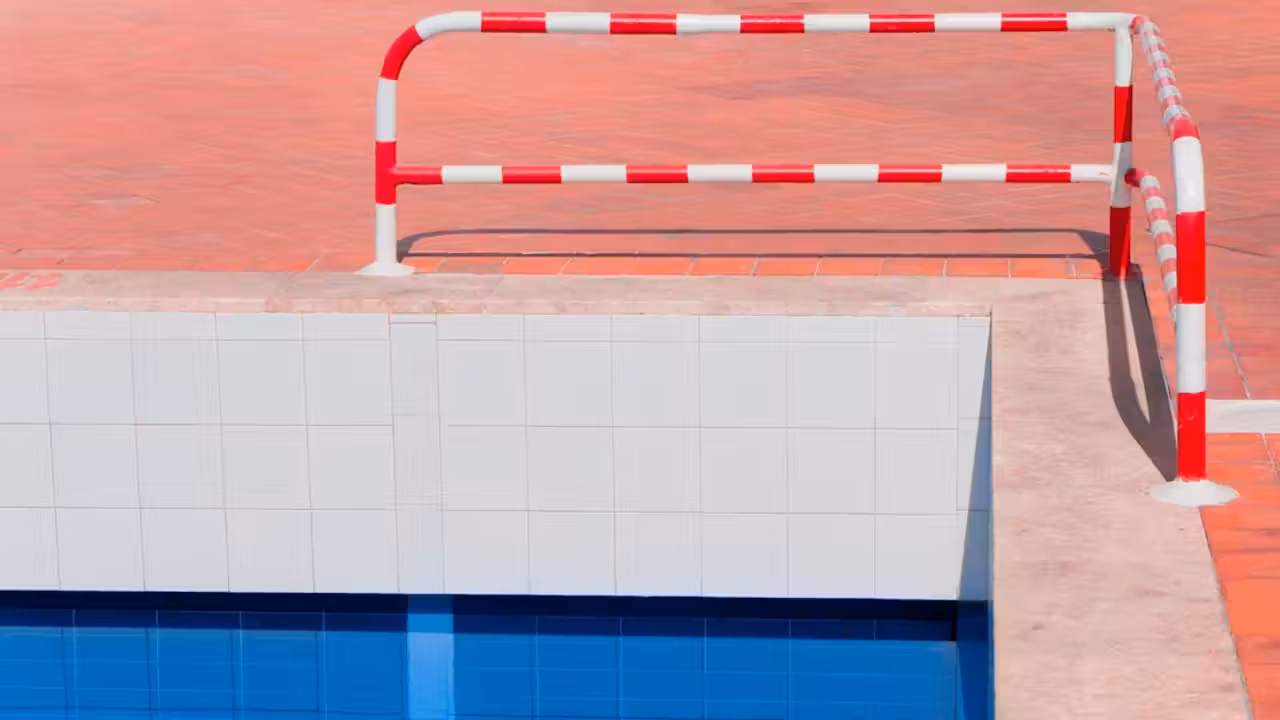Bassin intérieur municipal vide à Nice, entouré de plages en rénovation et d’équipements techniques protégés