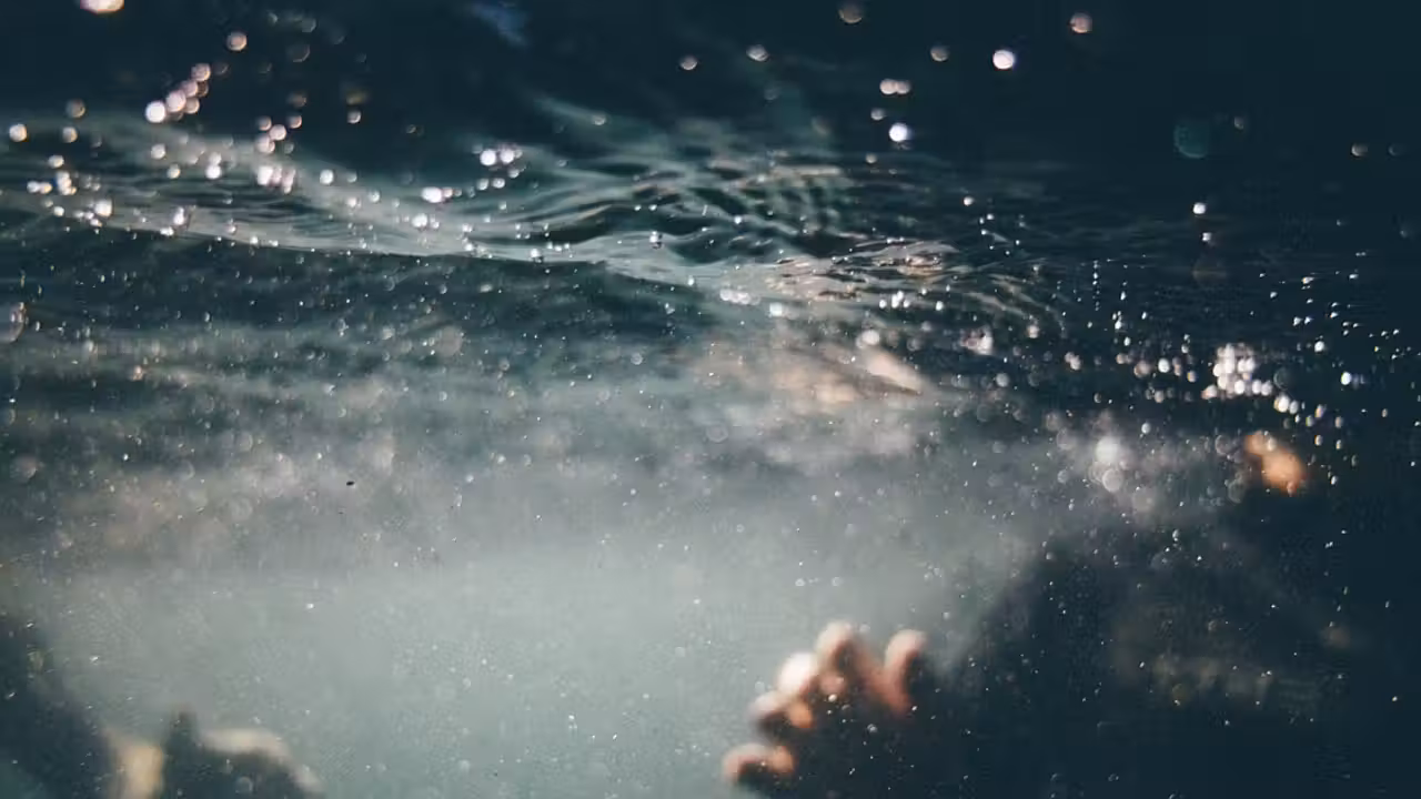 Technicien contrôlant l’étanchéité d’une piscine en béton avant la pose d’une membrane armée