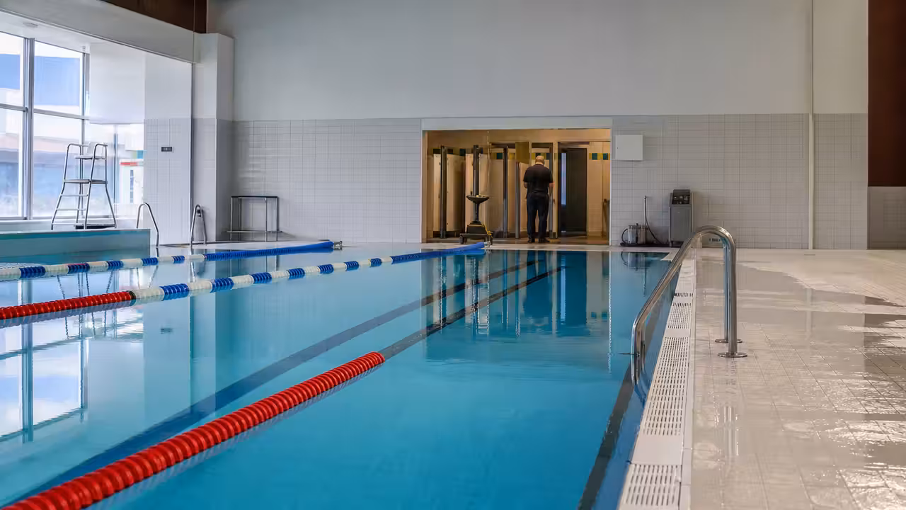 Bassin intérieur vide d’une piscine publique avec lignes d’eau et équipements techniques remis en service