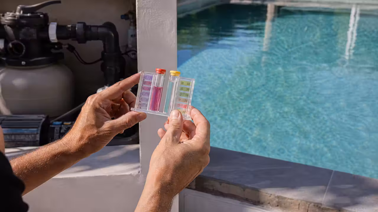 Analyse de l’eau d’une piscine privée avec éprouvettes de test près du local technique