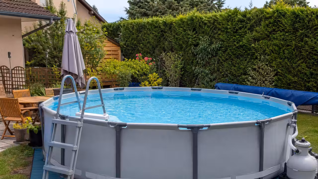 Piscine hors-sol tubulaire installée sur un terrain plat dans un jardin familial ensoleillé